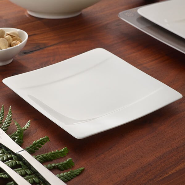 A white Villeroy & Boch Modern Grace square bread and butter plate on a white surface with a black border.