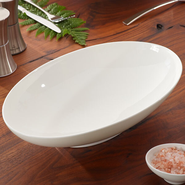 A white Villeroy & Boch oval bowl on a wooden table.