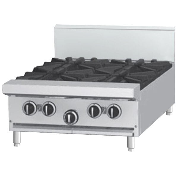 A Garland countertop gas range with a griddle over a stove top.