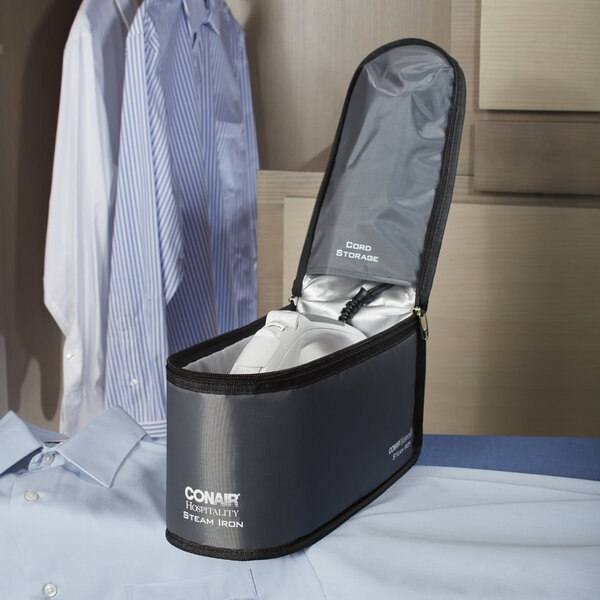 A Conair steam iron storage bag with a shirt and a pair of pants inside.