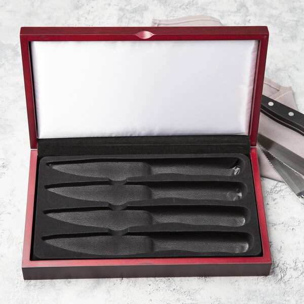 A Libbey wooden box with a knife set inside.