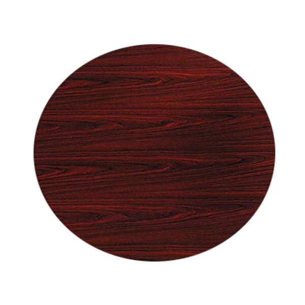 A close-up of a HON mahogany wood round table top.