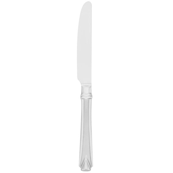 A silver Walco Athenian table knife with a white background.