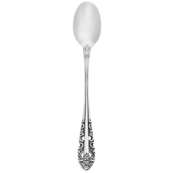 A close-up of a Walco stainless steel iced tea spoon with an ornate pattern.