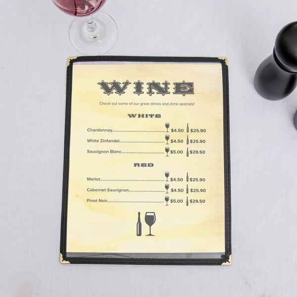 A Mediterranean villa themed menu inserted into a wine menu holder on a table with wine glasses.