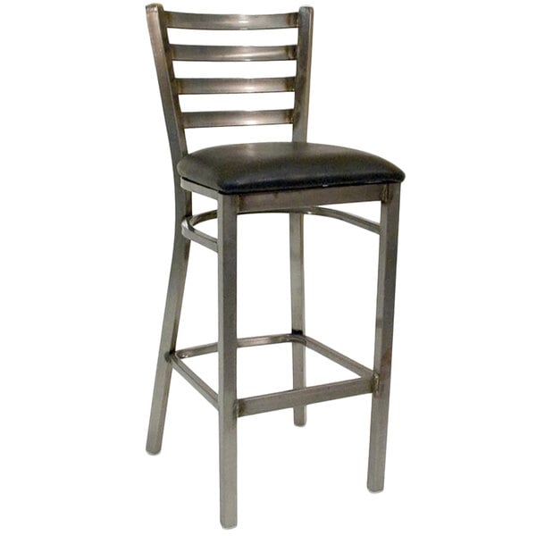 An American Tables & Seating metal barstool with a black seat.