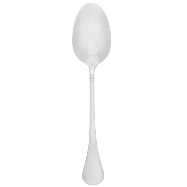 A Walco Soho stainless steel serving spoon with a white handle.