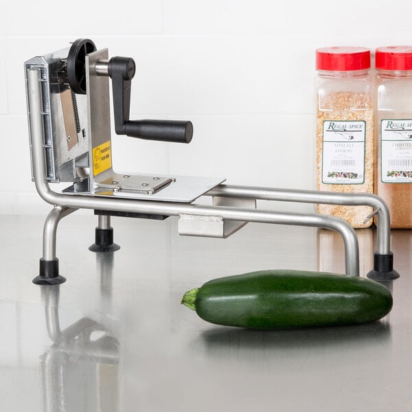 A Bron Coucke Le Rouet vegetable slicer on a counter with a zucchini.