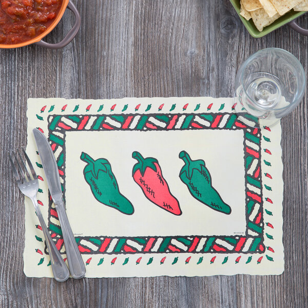 A Hoffmaster paper placemat with a picture of chili peppers on a table with a fork and knife.