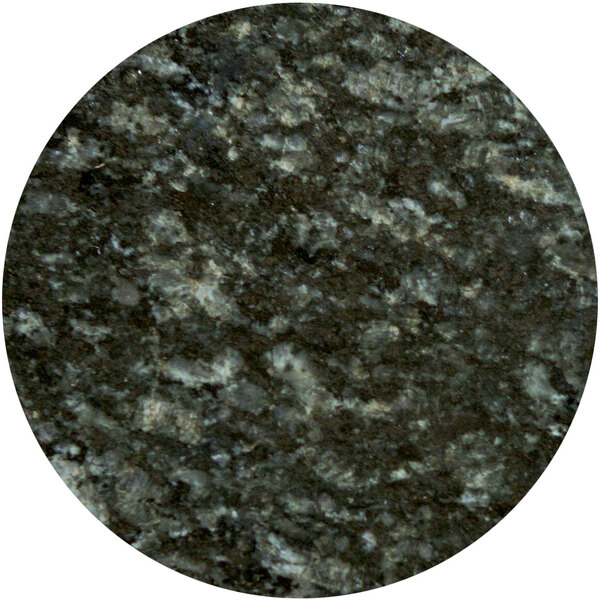 A close-up of an Art Marble Uba Tuba granite table top with a round shape and black and white speckled surface.