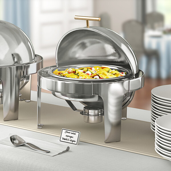 An Acopa Supreme gold accent round chafer on a hotel buffet table.