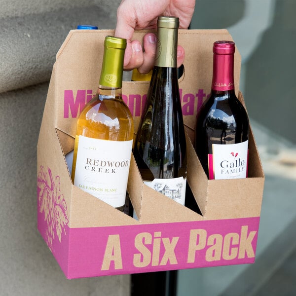 A 6 pack of wine bottles in a cardboard carrier.