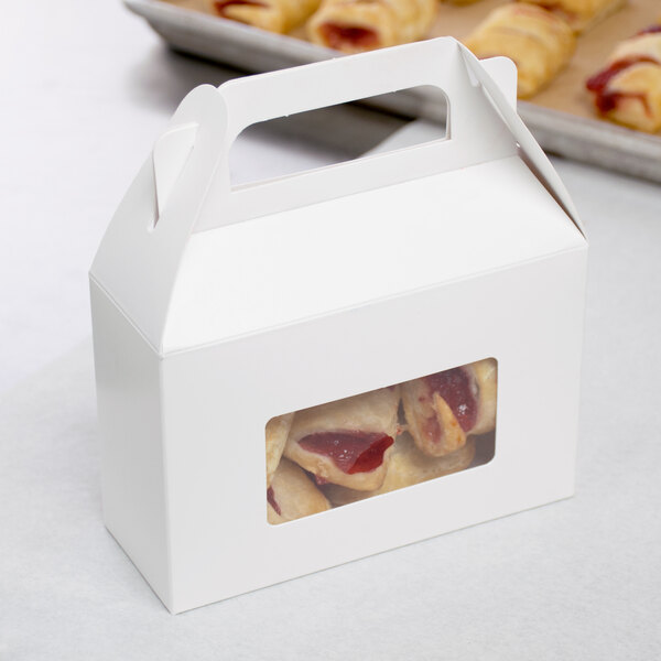 A white rectangle candy box with a window filled with pastries.