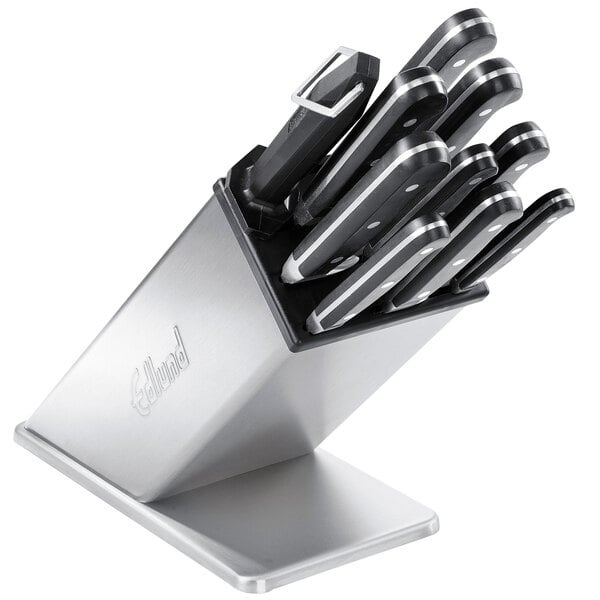 A set of black and silver knives in an Edlund stainless steel knife block.