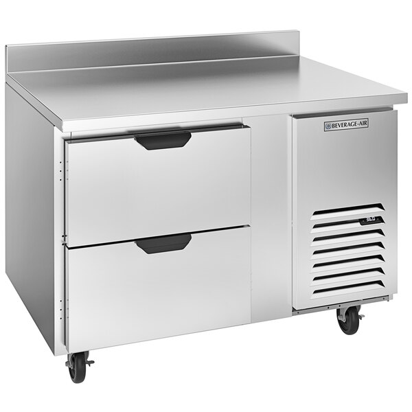 A stainless steel Beverage-Air worktop refrigerator with two drawers on wheels.
