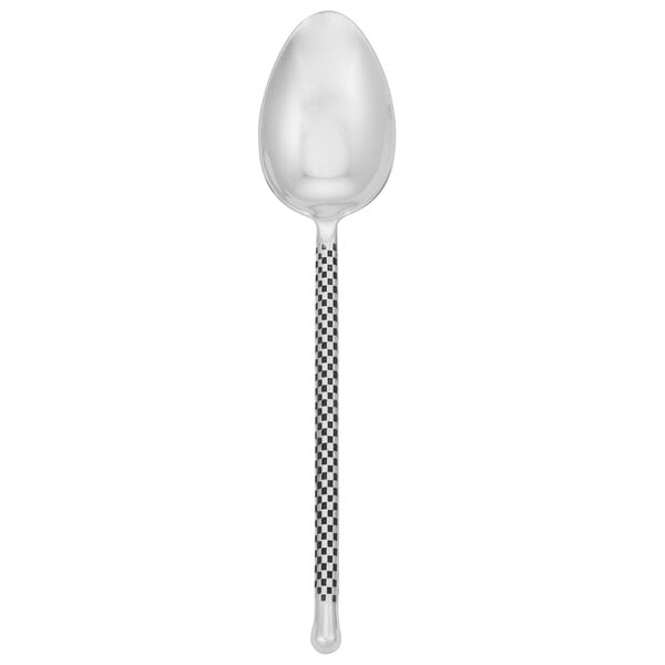 A silver Walco serving spoon with a black and white pattern on the handle.
