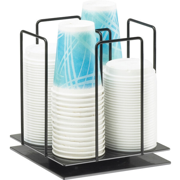 A black metal Cal-Mil revolving ramekin and lid organizer holding white and blue cups.
