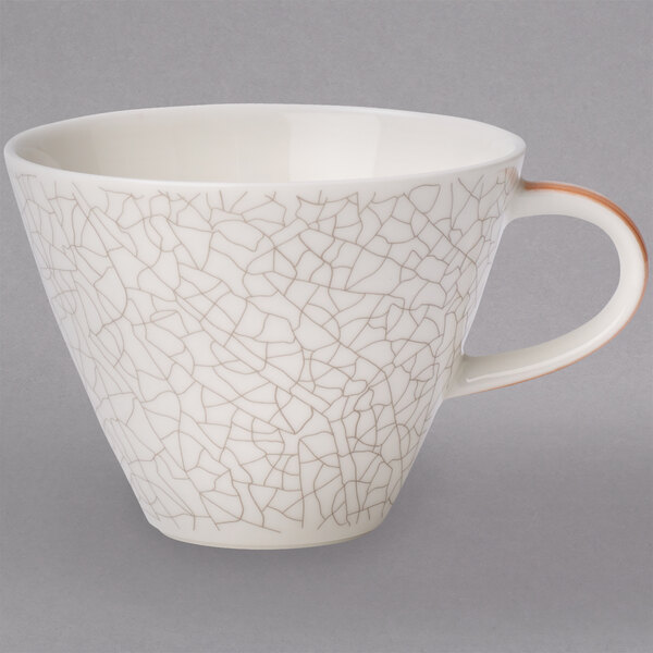 A white Terra Porcelain coffee cup with a crack pattern.