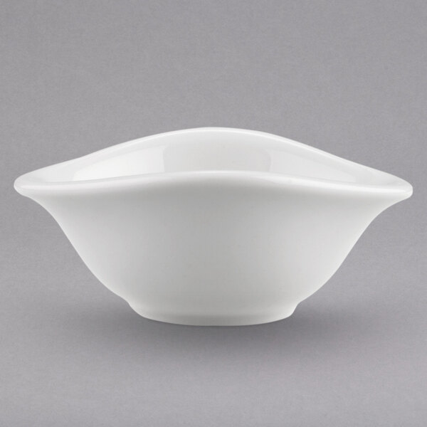 A close-up of a Villeroy & Boch white porcelain bowl with a curved edge.