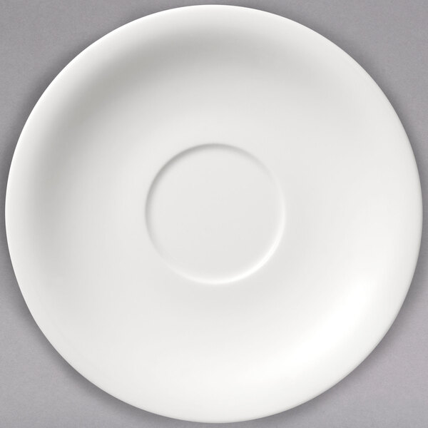 A white porcelain saucer with a circular rim and a circle in the center.