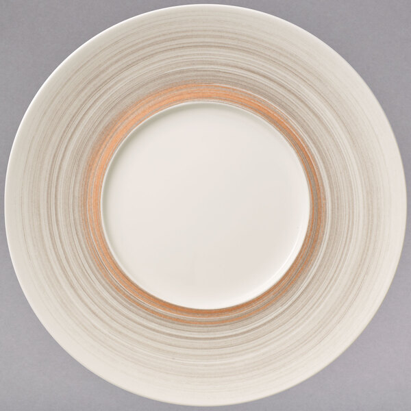 A white porcelain plate with a gold rim and a brown border.