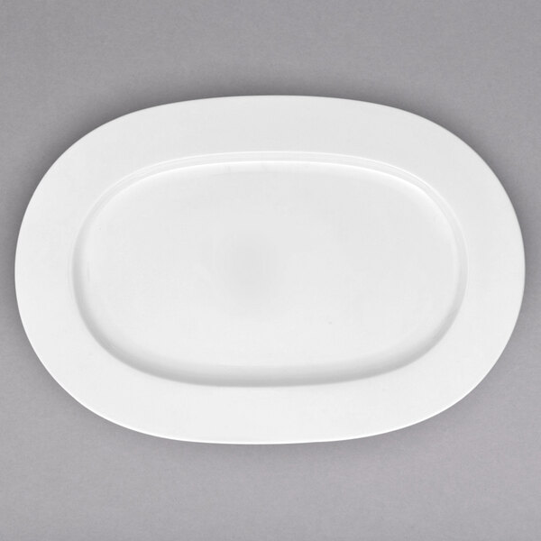A white bone porcelain oval platter with a white rim.