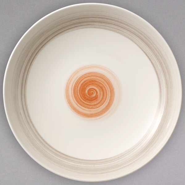 A Villeroy & Boch red porcelain bowl with a white spiral design on the inside.