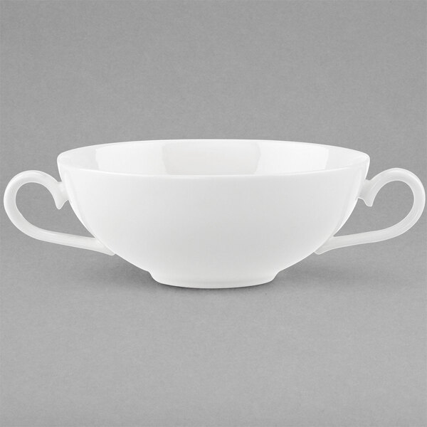 A white Villeroy & Boch bone porcelain bouillon cup with two handles on a gray surface.