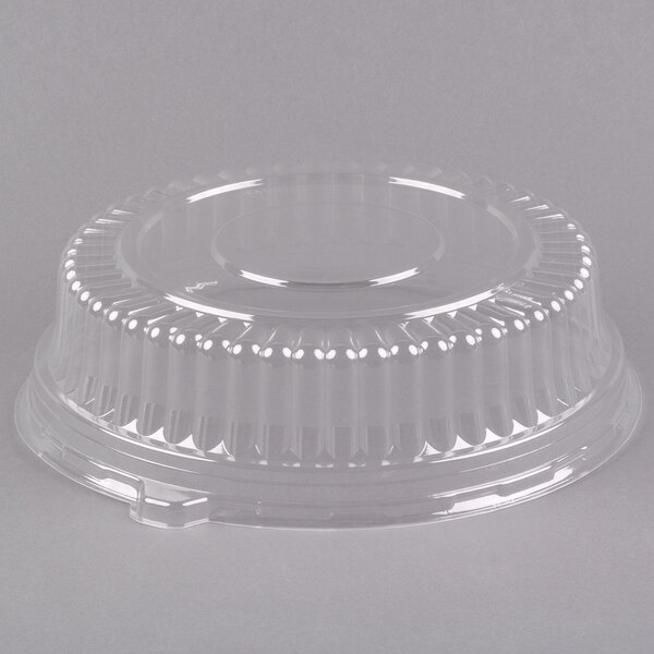 A clear plastic round high dome lid on a clear plastic container.
