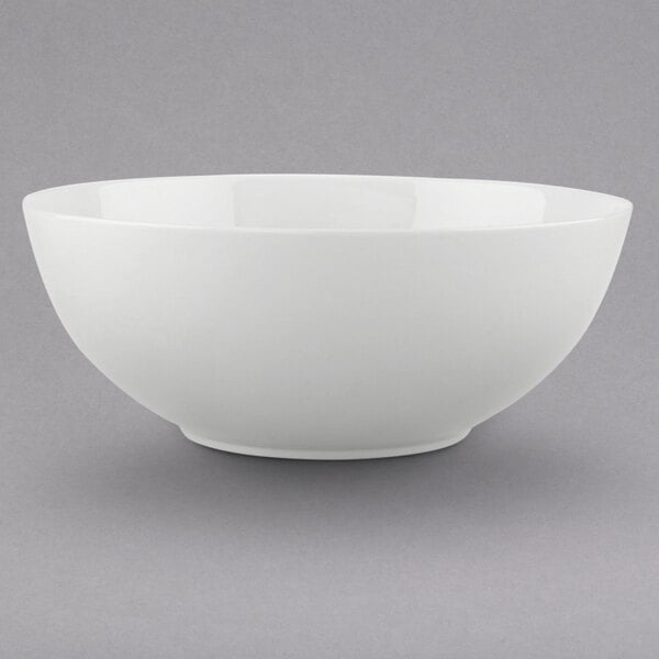 A Villeroy & Boch white bone porcelain salad bowl on a gray surface.