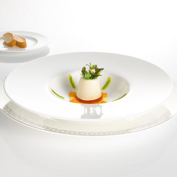 A white Villeroy & Boch bone porcelain deep plate with food on it.