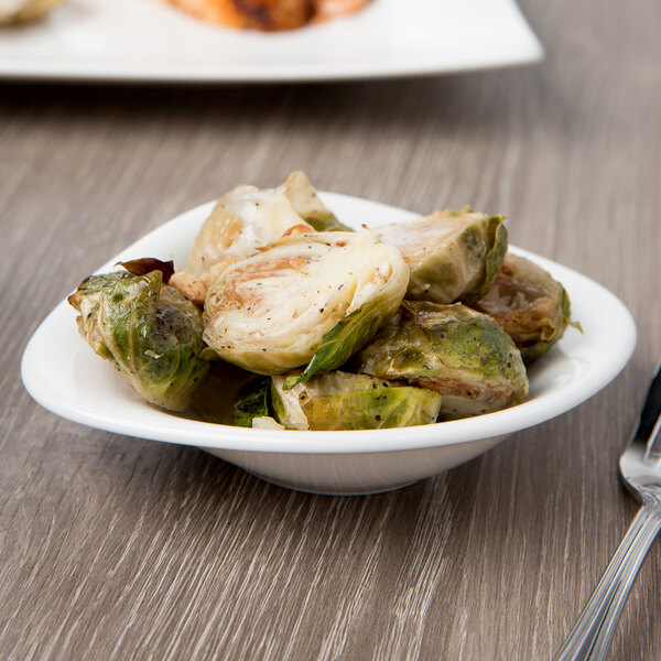 A white Villeroy & Boch porcelain bowl with cooked brussels sprouts.