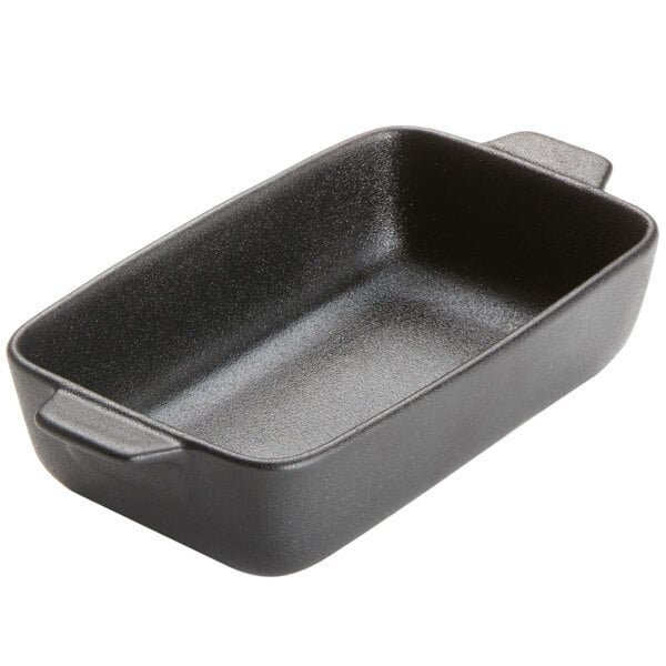 An American Metalcraft black rectangular casserole dish with handles on a kitchen counter.