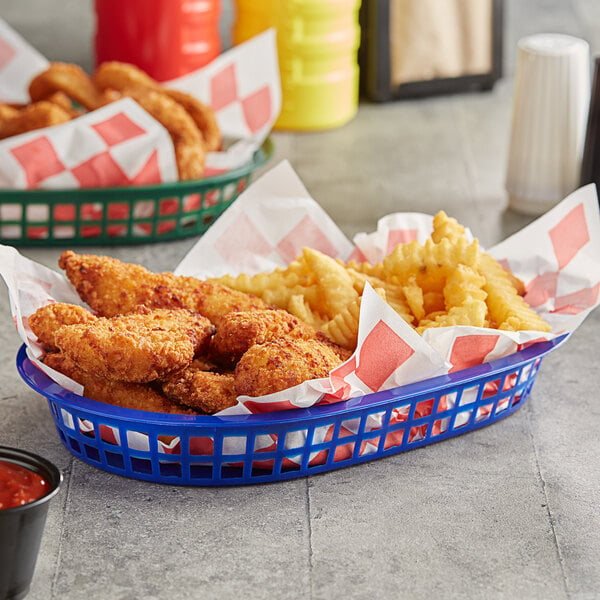 A blue oval plastic fast food basket filled with fried chicken and fries.