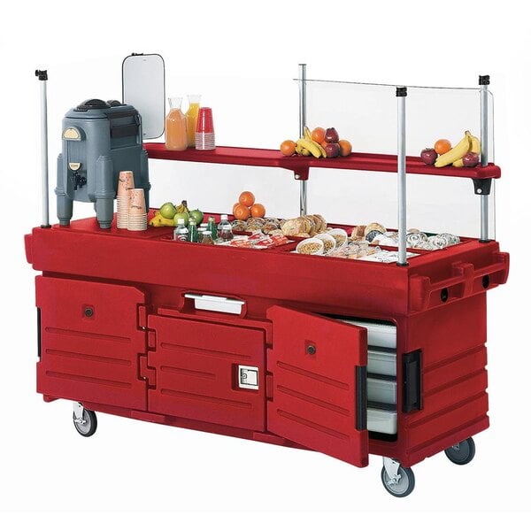 A red Cambro CamKiosk vending cart with food on it.
