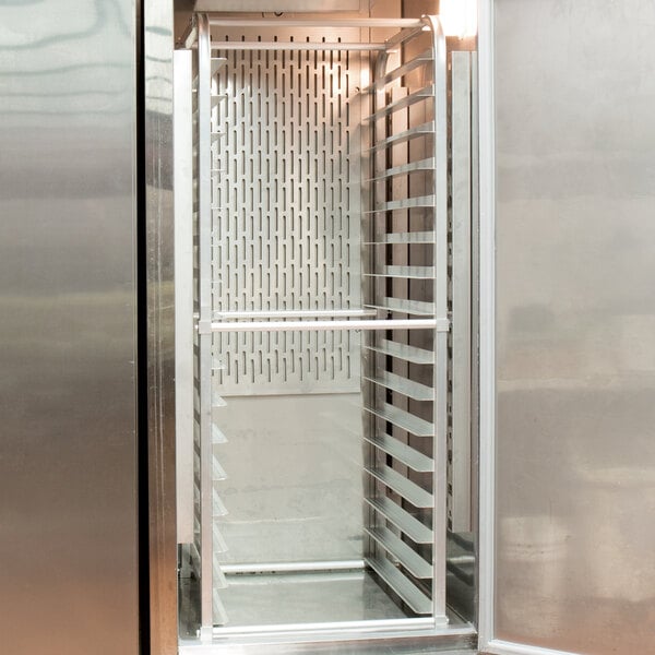 A Regency aluminum sheet pan rack in a school kitchen refrigerator.