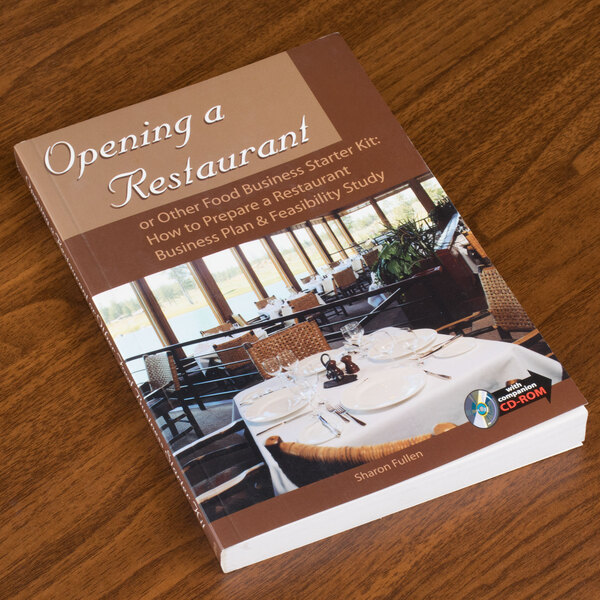 The cover of the book "Opening a Restaurant" on a table.