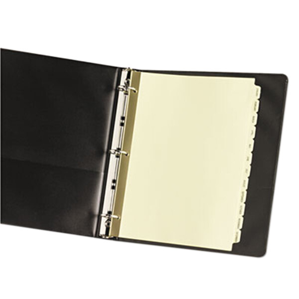 A black binder with white paper and yellow Avery monthly dividers inside.