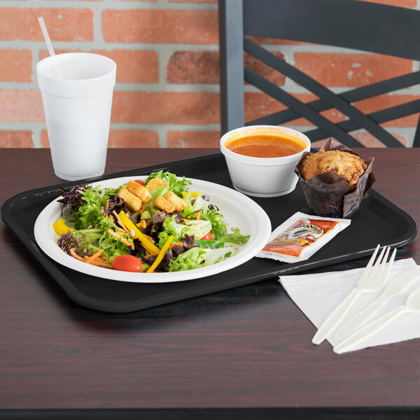 A Vollrath fast food tray with a cup of soup, salad, and a muffin on it.