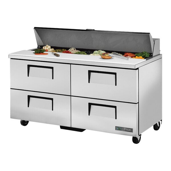 A True stainless steel refrigerated sandwich prep table with drawers on a counter.