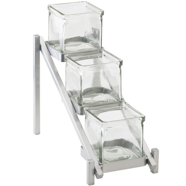 A Cal-Mil silver metal stand with three glass jars on it.