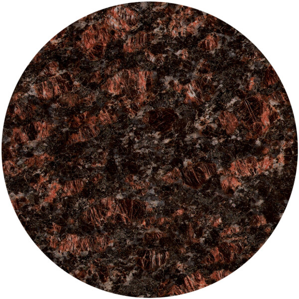 A close-up of a round tan brown granite tabletop with black and red specks.