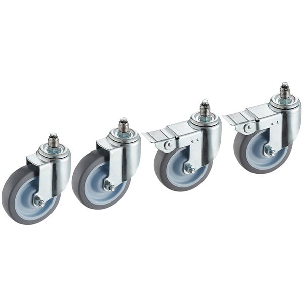 A row of four Cooking Performance convection oven casters with rubber wheels.