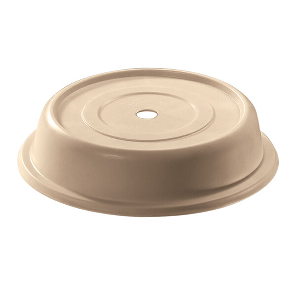 A beige plastic lid with a hole for a plate on a white background.