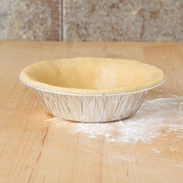 A D&W foil tart pan filled with a pie on a table.