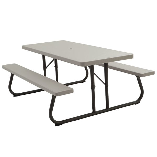 A rectangular putty plastic picnic table with attached benches.