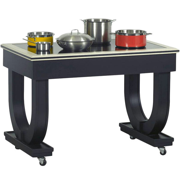 A Bon Chef rectangular table with a radiant heat surface and pots on it.