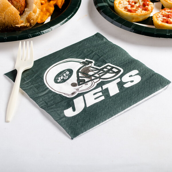 A plate of food with a New York Jets luncheon napkin.