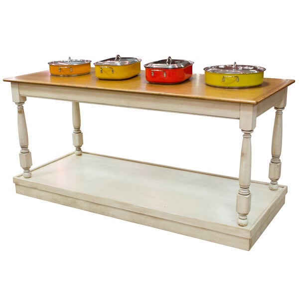 A Bon Chef rectangular country style mobile table with yellow and silver pots on top.