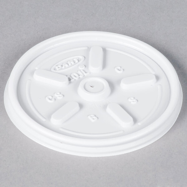 A close-up of a white plastic Dart lid with a circular hole.